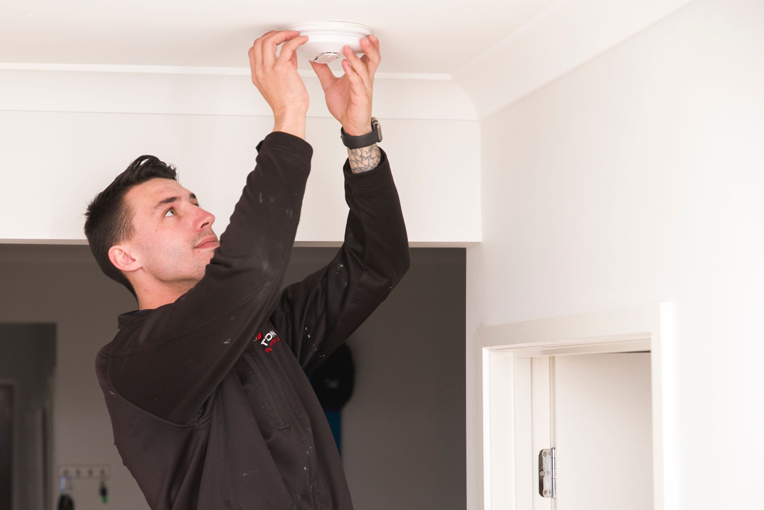 Electrician Installing Smoke Alarm