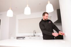 Mick the electrician installing pendant lights for a customer