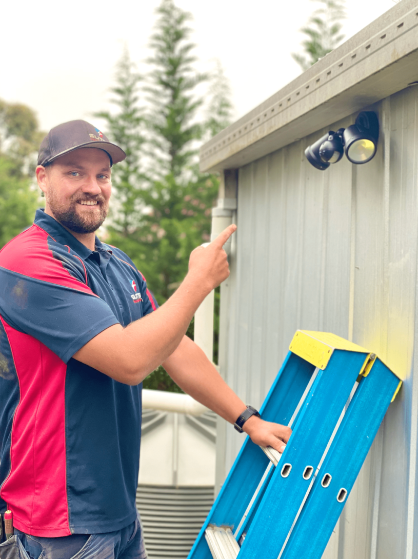 Electrician installing sensor light