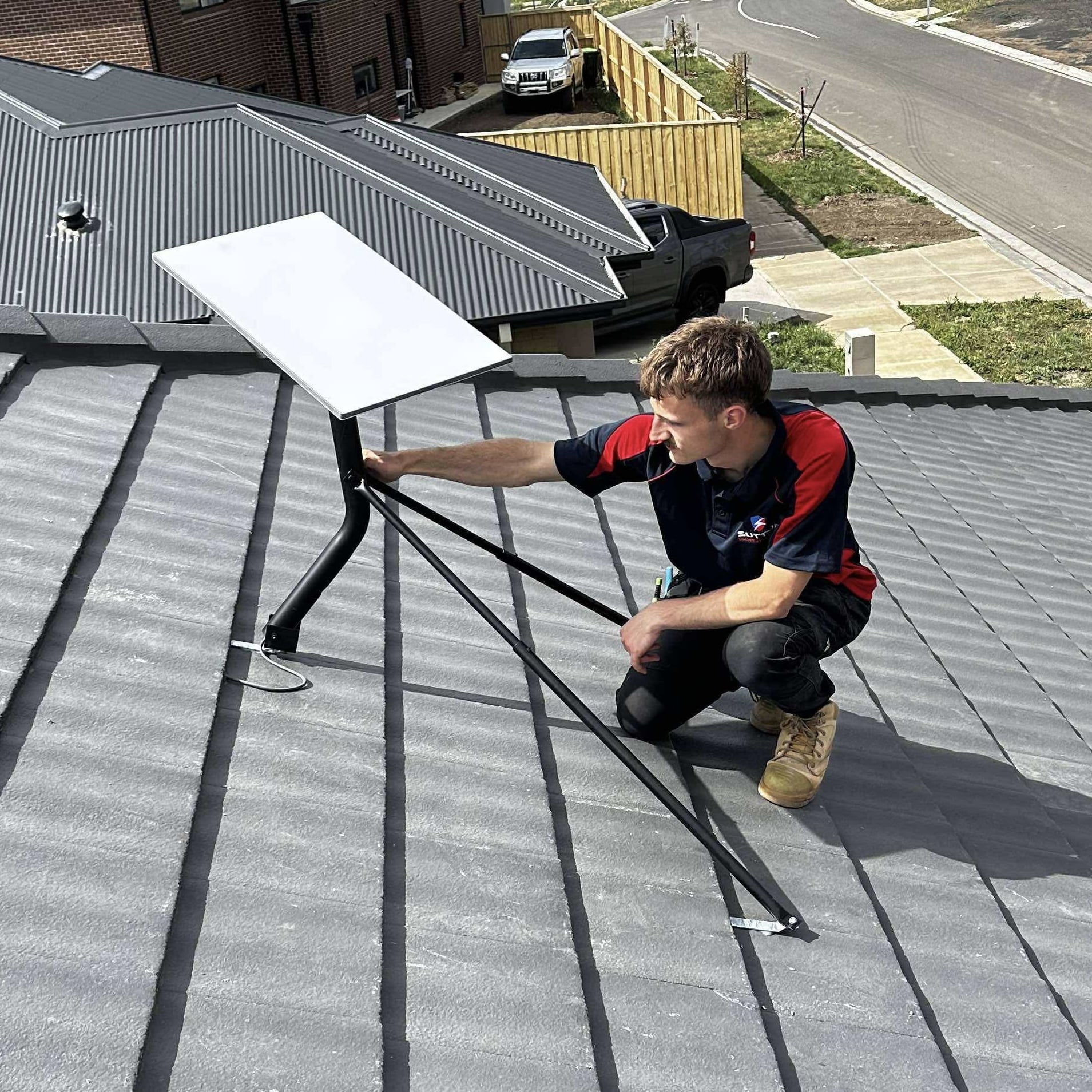 Electrician installing starlink on a customers roof